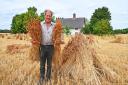 Farmer Patrick Murray with his 5ft 'shocks' of heritage wheat grown for thatching straw at Blo' Norton