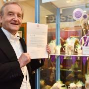 Diss Museum manager Basil Abbott with letter from the Queen's Lady-in-Waiting.