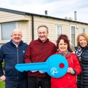 Lucky holiday home winners Mark and Janet Vinnicombe, pictured with Justin Ettridge of Richardson's (left) and Debbie Noye from Archant (right) at Richardson's Hemsby Beach Holiday Park