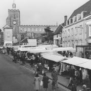 Shoppers bustle about at Diss market in 1979.