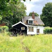 The cottage, ripe for renovation, for sale.