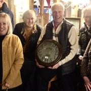 Regulars and volunteers at the Fox Inn, Garboldisham, with the clock  Picture: Eddie Theaker