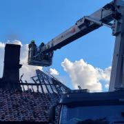The roof of a farmhouse in mid Suffolk has been destroyed after a fire
