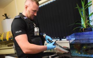 Dereham police carry out a drugs raid on a property in Sandy Lane. PC Stu Lyle with a knife he has found. Picture: DENISE BRADLEY